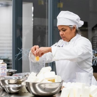 Chef preparing food in a kitchen.